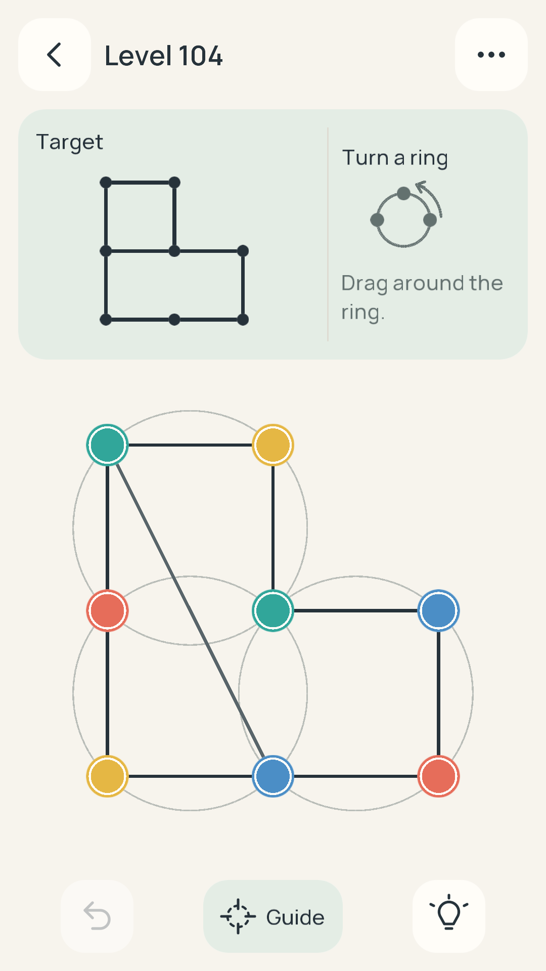 An unsolved Retangle Orbits puzzle with connected colored dots on three overlapping rings and a target above.